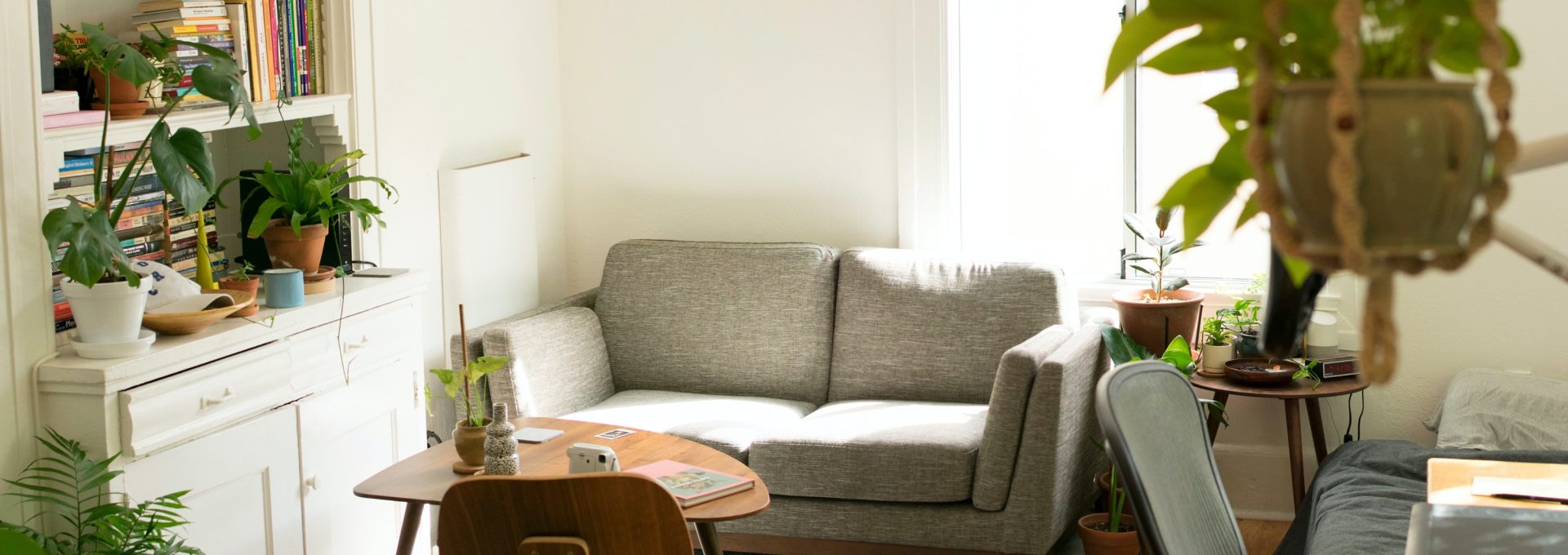 gray fabric loveseat near brown wooden table